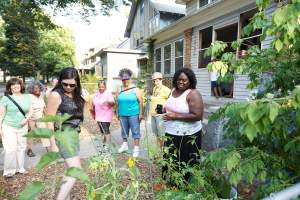 Touring OKT in-yard food gardens. Photo courtesy W K Kellogg Foundation.